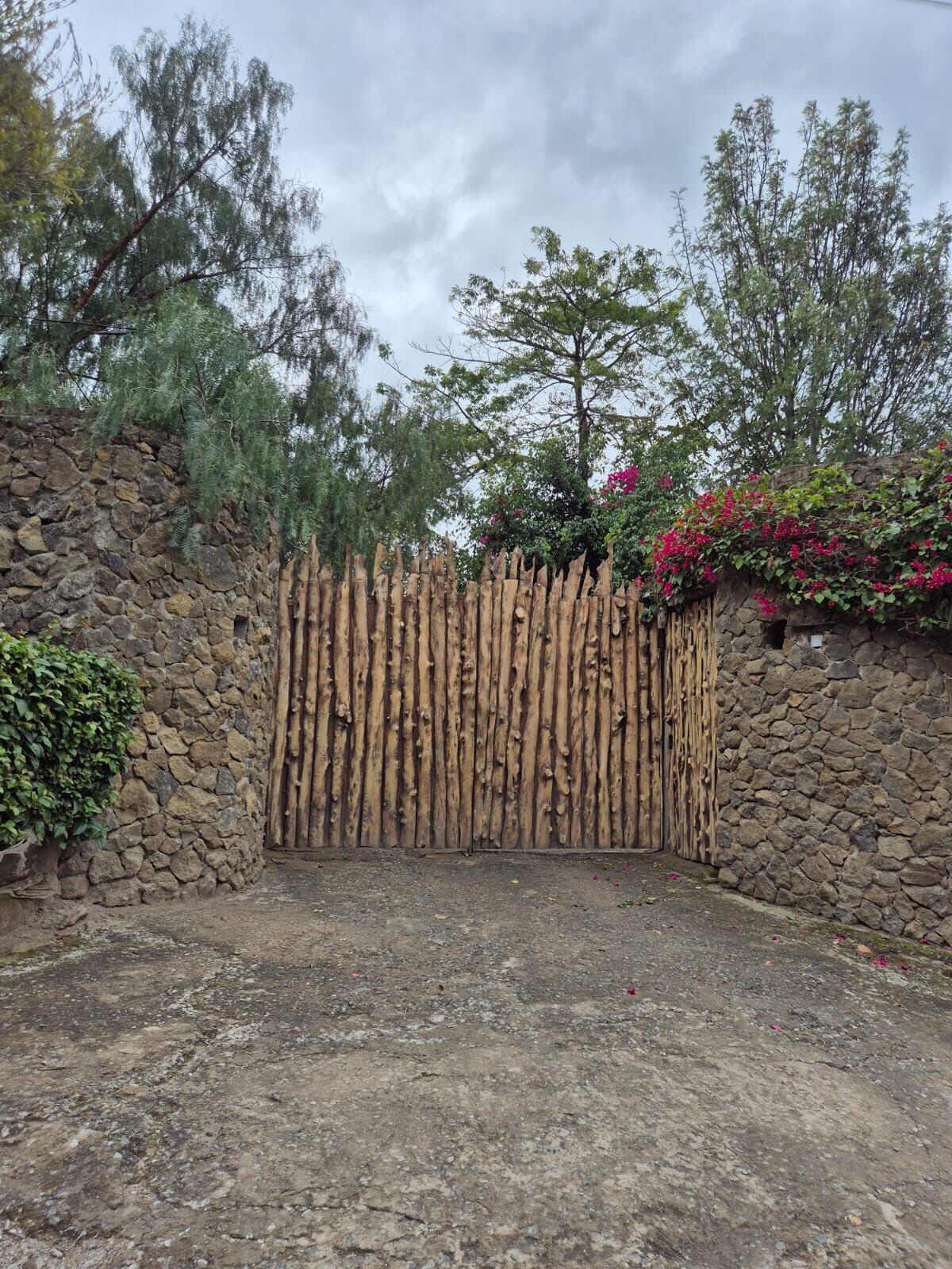 The wooden entrance gate at Merinja Guesthouse
