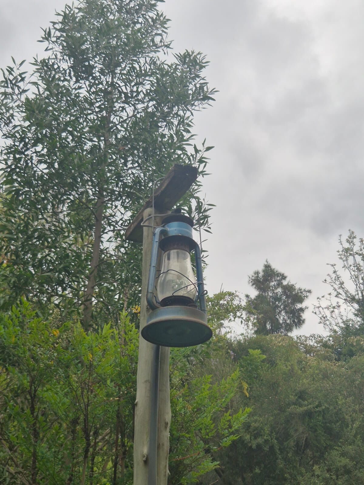 A solar lantern on a wooden pole